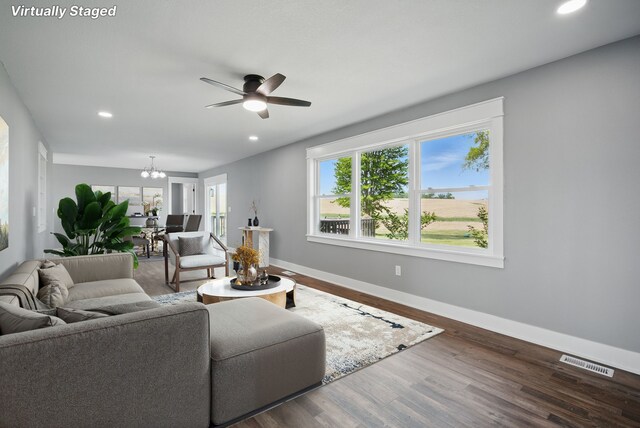 1026 44th Hwy, Guthrie Center, IA 50115 - living room with baseboards, ceiling fan, plenty of natural light, recessed lighting, and a chandelier