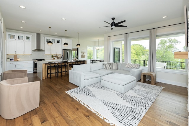 1030 Harrington Way, Waukee, IA 50263 - living area with a ceiling fan, healthy amount of natural light, recessed lighting, and hardwood / wood-style floors