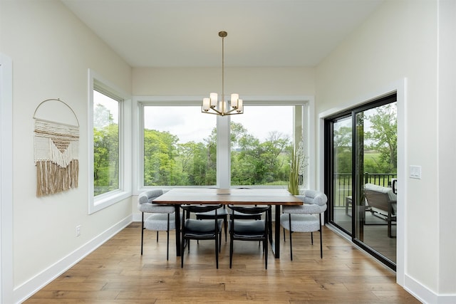 1030 Harrington Way, Waukee, IA 50263 - dining room featuring plenty of natural light, wood finished floors, and a chandelier