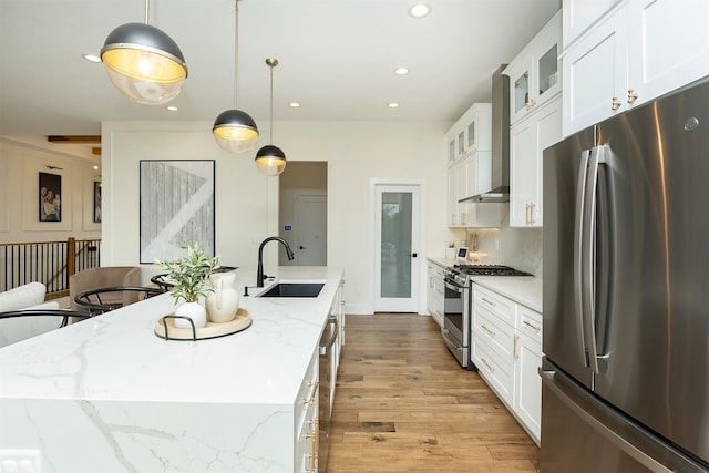1030 Harrington Way, Waukee, IA 50263 - kitchen featuring appliances with stainless steel finishes, a kitchen island with sink, light wood finished floors, white cabinets, and recessed lighting