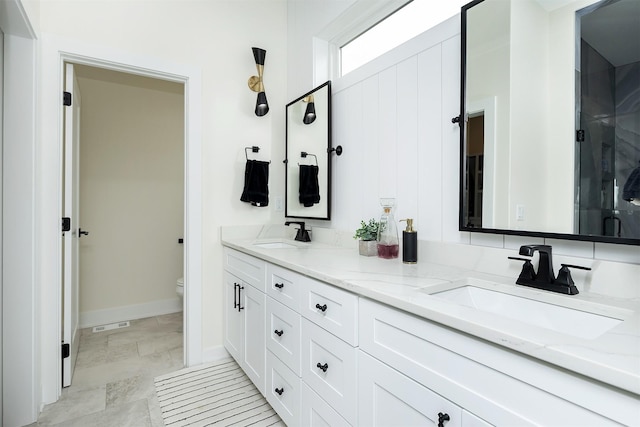 1030 Harrington Way, Waukee, IA 50263 - bathroom featuring double vanity and a shower with door