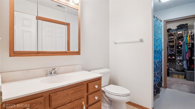 1105 E Henderson Pl, Indianola, IA 50125 - full bathroom with vanity, toilet, and a spacious closet
