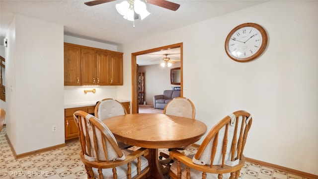 1105 E Henderson Pl, Indianola, IA 50125 - dining room with light floors, ceiling fan, and baseboards