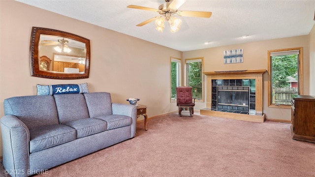 1105 E Henderson Pl, Indianola, IA 50125 - carpeted living room featuring baseboards, ceiling fan, and healthy amount of natural light