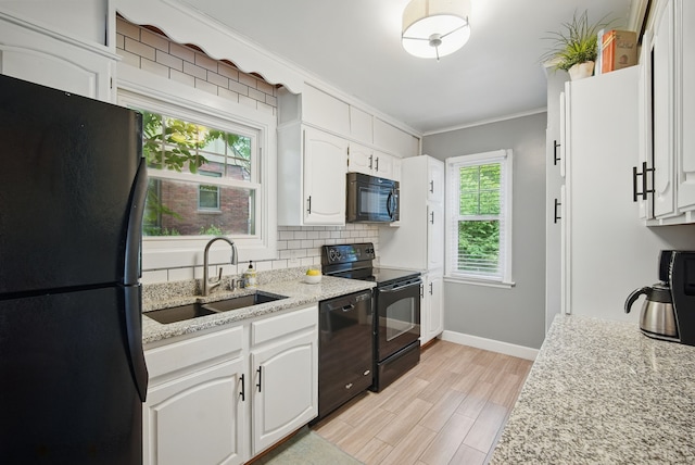 1526 41st Pl, Des Moines, IA 50311 - kitchen featuring black appliances, a sink, crown molding, backsplash, and white cabinetry