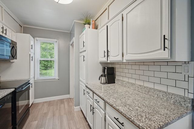 1526 41st Pl, Des Moines, IA 50311 - kitchen featuring black appliances, backsplash, baseboards, white cabinets, and crown molding