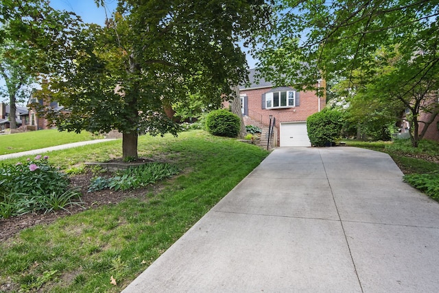 1526 41st Pl, Des Moines, IA 50311 - view of front facade with brick siding, concrete driveway, a garage, and a front lawn