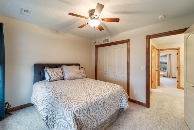 1738 Everwood Ct SW, Altoona, IA 50009 - bedroom featuring carpet floors, a closet, baseboards, a ceiling fan, and a textured ceiling