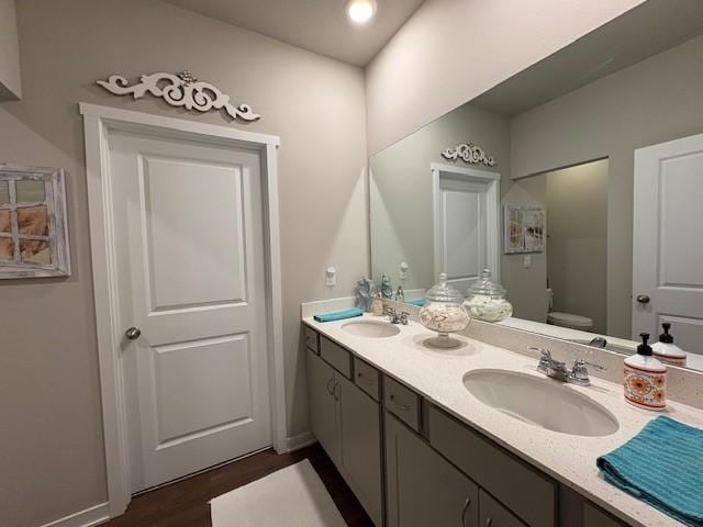 2807 NW 31st St, Ankeny, IA 50023 - bathroom featuring toilet, double vanity, wood finished floors, recessed lighting, and baseboards