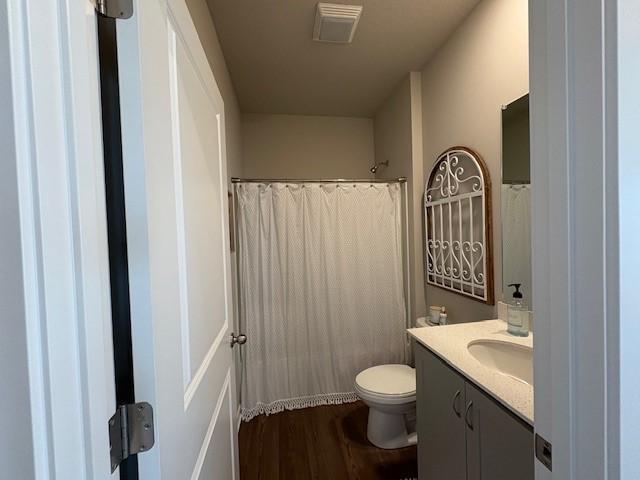 2807 NW 31st St, Ankeny, IA 50023 - bathroom with vanity, toilet, wood finished floors, and curtained shower
