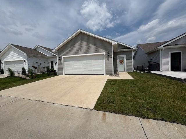 2807 NW 31st St, Ankeny, IA 50023 - ranch-style home featuring concrete driveway, a front lawn, and an attached garage