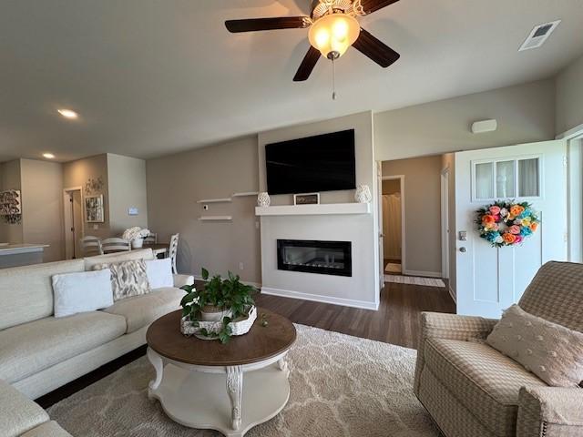 2807 NW 31st St, Ankeny, IA 50023 - living area with wood finished floors, recessed lighting, a glass covered fireplace, and a ceiling fan