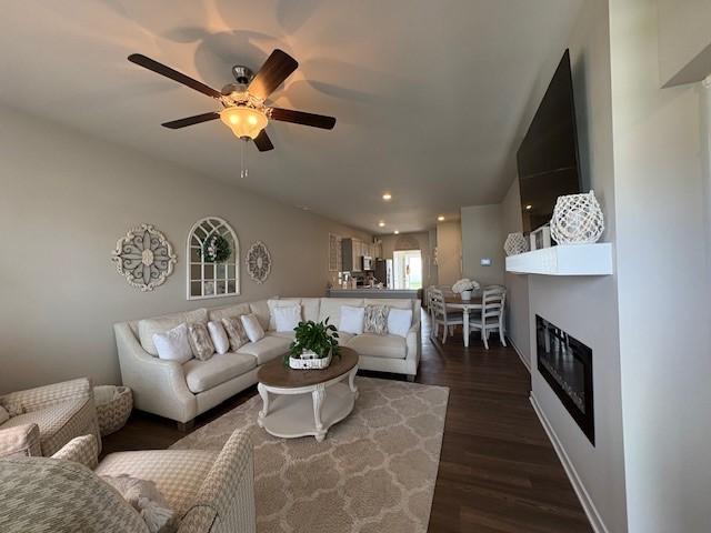 2807 NW 31st St, Ankeny, IA 50023 - living room with a ceiling fan, dark wood-type flooring, a glass covered fireplace, and recessed lighting