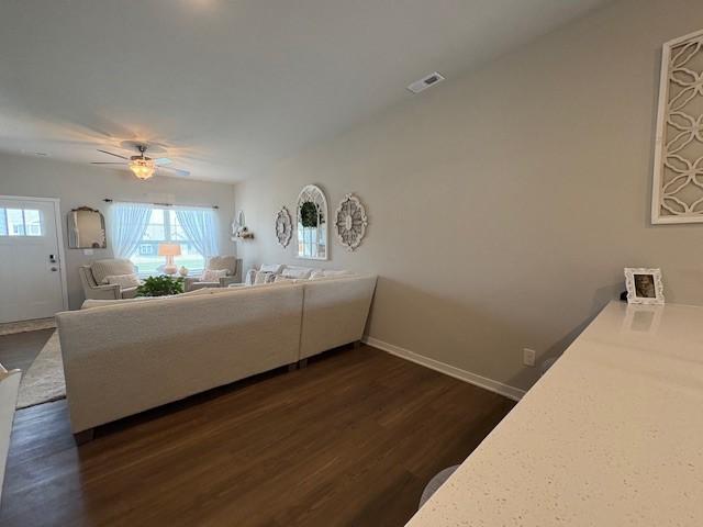 2807 NW 31st St, Ankeny, IA 50023 - living room featuring dark wood-style flooring, plenty of natural light, ceiling fan, and baseboards