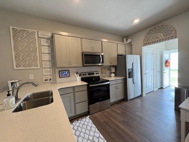 2807 NW 31st St, Ankeny, IA 50023 - kitchen featuring stainless steel appliances, a sink, gray cabinets, light countertops, and recessed lighting