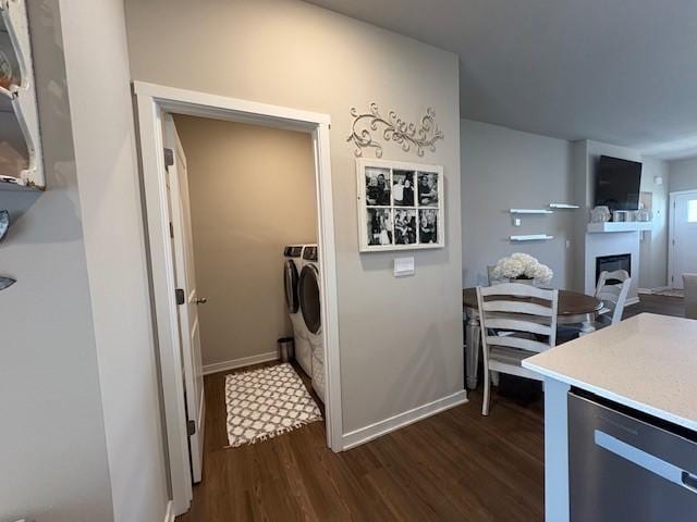 2807 NW 31st St, Ankeny, IA 50023 - laundry room featuring independent washer and dryer, dark wood-style flooring, a fireplace, and baseboards