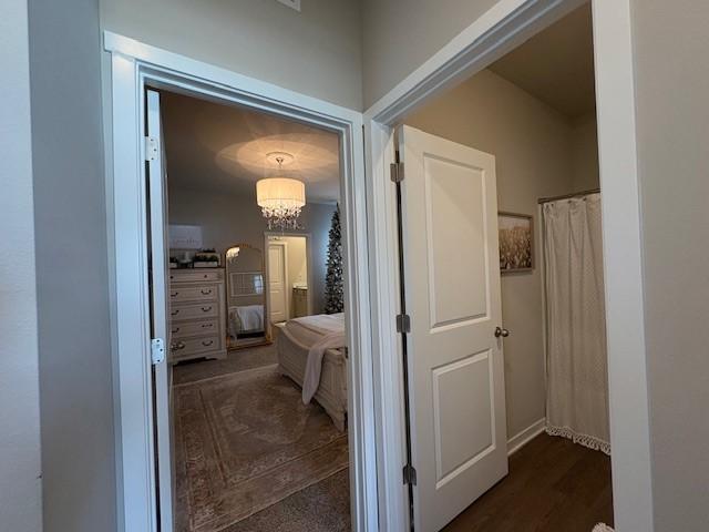 2807 NW 31st St, Ankeny, IA 50023 - hallway featuring a chandelier and wood finished floors