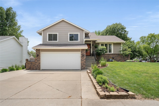 9640 Quail Run, Urbandale, IA 50322 - tri-level home with brick siding, a garage, a front yard, and driveway
