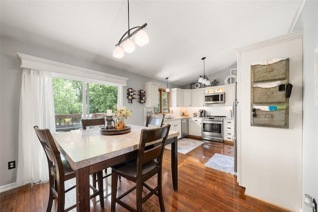 9640 Quail Run, Urbandale, IA 50322 - dining area with vaulted ceiling and dark wood finished floors
