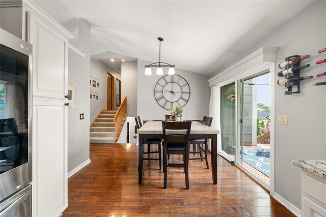 9640 Quail Run, Urbandale, IA 50322 - dining area featuring lofted ceiling, dark wood-style floors, stairs, and baseboards
