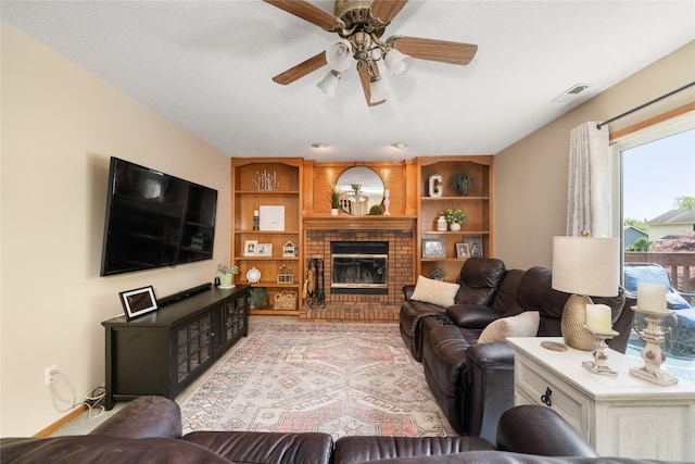 9640 Quail Run, Urbandale, IA 50322 - living area with ceiling fan, a fireplace, and built in features