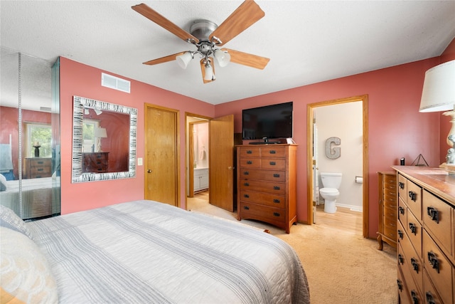 9640 Quail Run, Urbandale, IA 50322 - bedroom featuring ensuite bathroom, light carpet, and ceiling fan