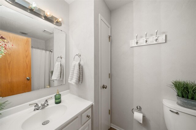 9640 Quail Run, Urbandale, IA 50322 - bathroom featuring vanity and toilet