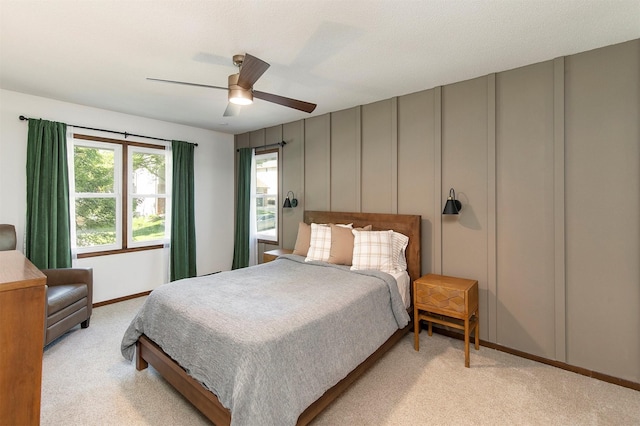 9873 Colby Ave, Clive, IA 50325 - bedroom featuring a decorative wall, light colored carpet, and a ceiling fan