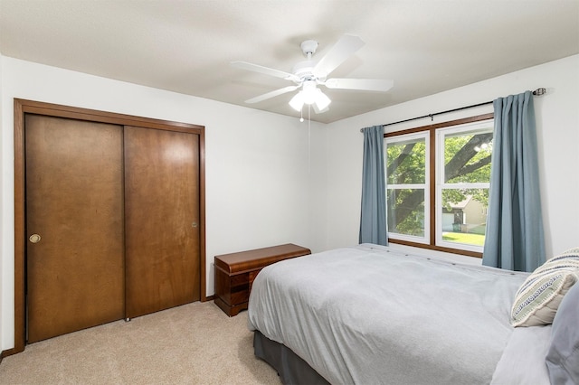 9873 Colby Ave, Clive, IA 50325 - bedroom featuring light carpet, a closet, and a ceiling fan