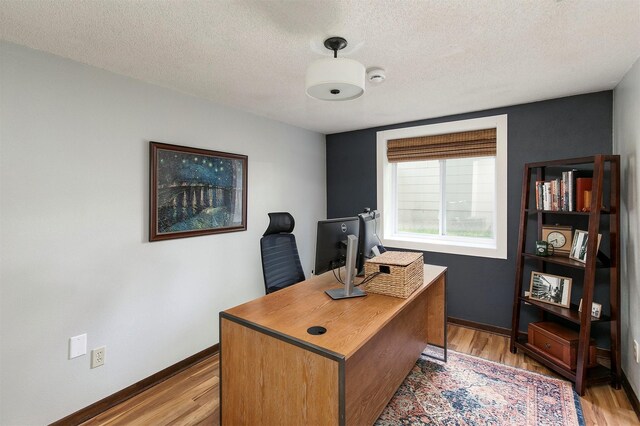 9873 Colby Ave, Clive, IA 50325 - home office featuring light wood-type flooring, a textured ceiling, and baseboards