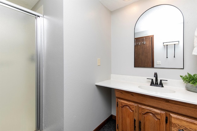 9873 Colby Ave, Clive, IA 50325 - full bathroom with vanity, a shower stall, and baseboards
