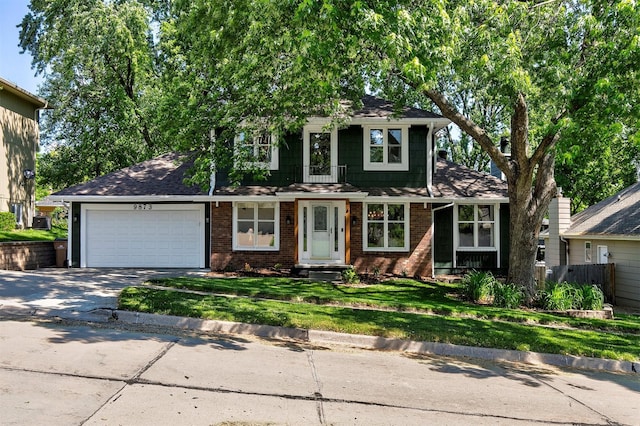 9873 Colby Ave, Clive, IA 50325 - view of front facade featuring concrete driveway, a garage, brick siding, and roof with shingles