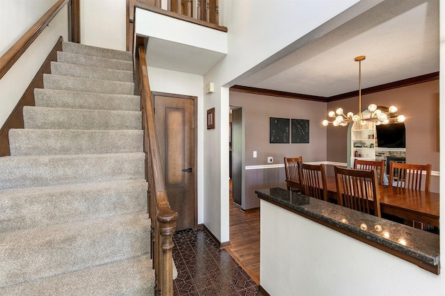 9873 Colby Ave, Clive, IA 50325 - staircase featuring a chandelier and ornamental molding