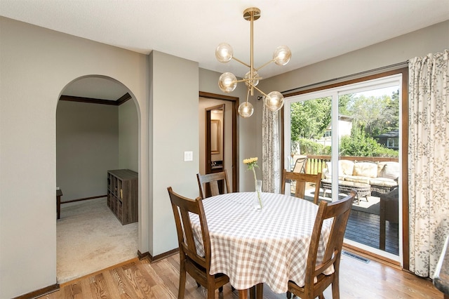 9873 Colby Ave, Clive, IA 50325 - dining space with arched walkways, light wood-type flooring, and baseboards