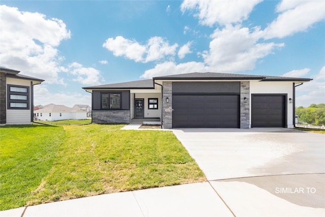 610 Ellis Cir, Adel, IA 50003 - prairie-style house with an attached garage, driveway, a front yard, and stucco siding