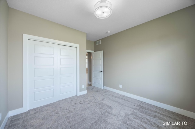 610 Ellis Cir, Adel, IA 50003 - unfurnished bedroom featuring carpet flooring, a closet, and baseboards