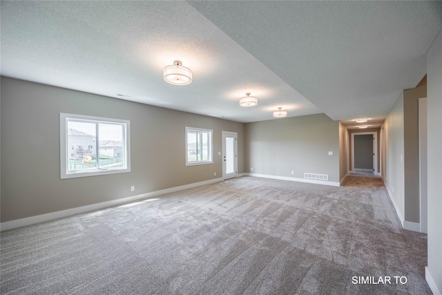 610 Ellis Cir, Adel, IA 50003 - empty room with carpet flooring, baseboards, and a textured ceiling