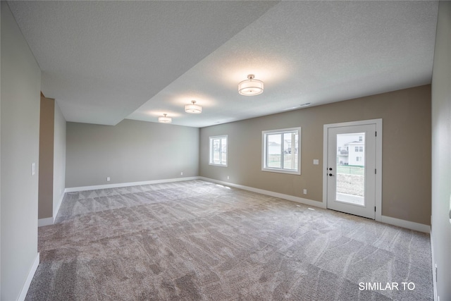 610 Ellis Cir, Adel, IA 50003 - spare room with carpet, baseboards, and a textured ceiling
