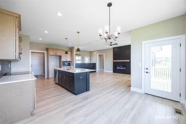 610 Ellis Cir, Adel, IA 50003 - kitchen with a sink, a chandelier, light countertops, light wood-style floors, and recessed lighting