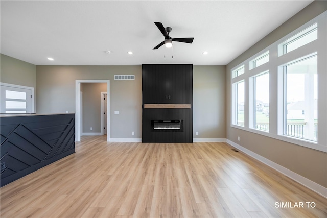 610 Ellis Cir, Adel, IA 50003 - unfurnished living room featuring ceiling fan, light wood finished floors, a fireplace, baseboards, and recessed lighting