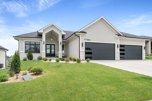 17594 Townsend Dr, Clive, IA 50325 - view of front of house featuring french doors, stone siding, a garage, and a front lawn