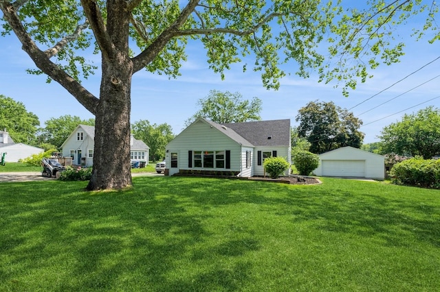 3811 E 30th St, Des Moines, IA 50317 - rear view of house with a detached garage, a lawn, and an outdoor structure