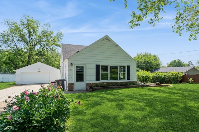 3811 E 30th St, Des Moines, IA 50317 - view of front of house featuring an outdoor structure, a garage, a front lawn, and roof with shingles