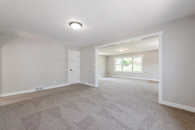 3811 E 30th St, Des Moines, IA 50317 - spare room featuring carpet and baseboards