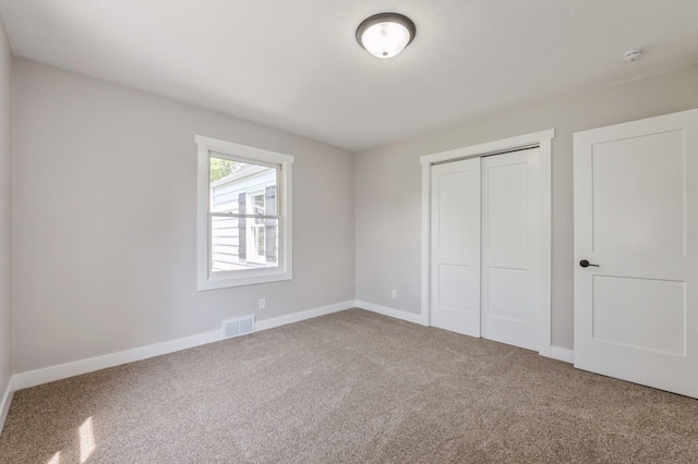 3811 E 30th St, Des Moines, IA 50317 - unfurnished bedroom featuring carpet floors, a closet, and baseboards