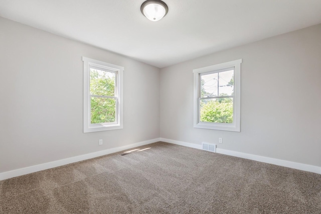 3811 E 30th St, Des Moines, IA 50317 - spare room featuring healthy amount of natural light, carpet floors, and baseboards