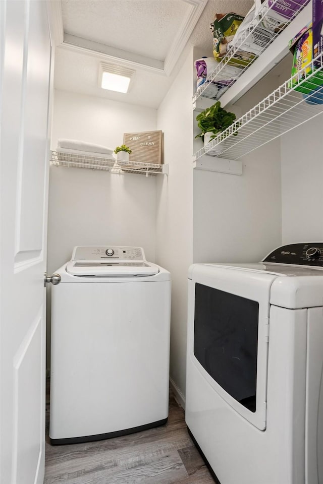 2150 NE 18th St Unit 101, Grimes, IA 50111 - laundry area with washer and dryer and wood finished floors