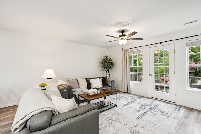2150 NE 18th St Unit 101, Grimes, IA 50111 - living room with wood finished floors, baseboards, and a ceiling fan