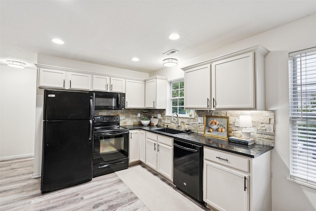 2150 NE 18th St Unit 101, Grimes, IA 50111 - kitchen with black appliances, a sink, dark countertops, light wood-type flooring, and recessed lighting