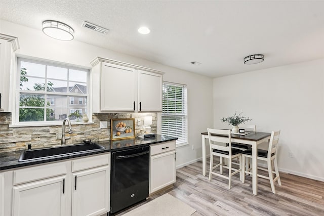 2150 NE 18th St Unit 101, Grimes, IA 50111 - kitchen with dishwasher, a sink, dark countertops, backsplash, and recessed lighting